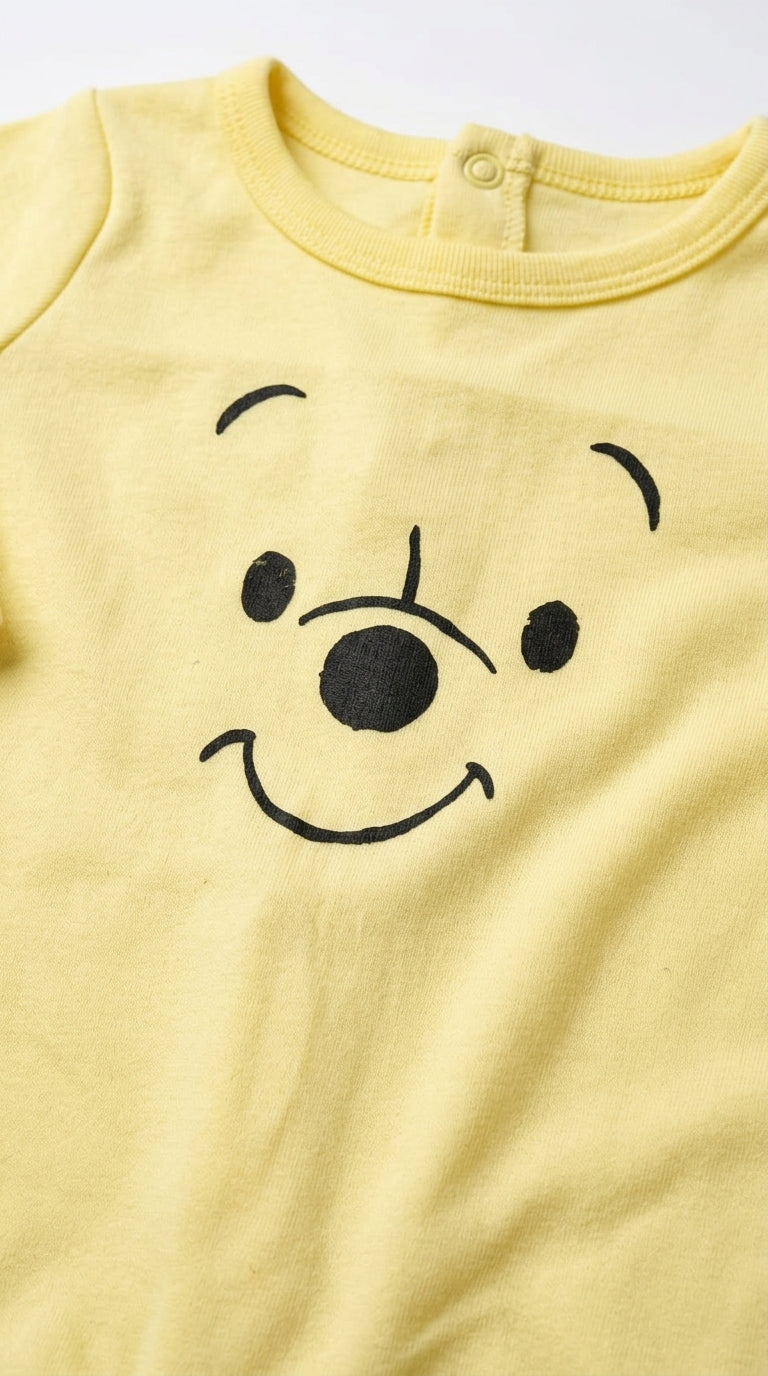 Winnie the Pooh – Yellow baby footed romper